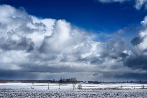 istock Heavy snow storm clouds over fields in countryside 907752796