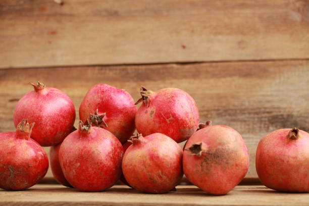 istock pomegranates on a wooden table 907758676