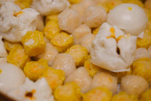 istock Dim Sum dumplings and steamed buns in the container 907760046