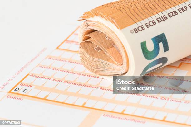 A Form For A Bank Transfer And Euro Banknotes Stock Photo - Download Image Now - Bank Deposit Slip, Money Transfer, Money Order