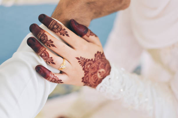 istock Midsection Of Bride Holding Bridegroom Hand During Wedding 907768596