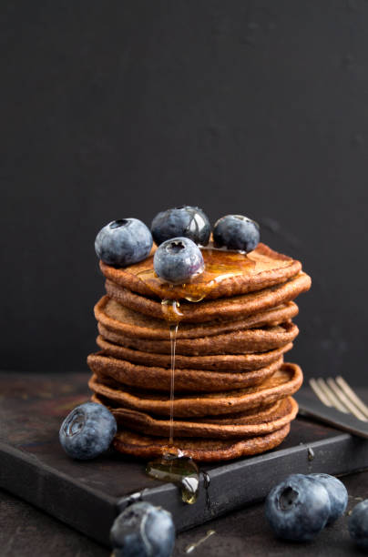 istock Chocolate pancakes with blueberries on a dark background. 907768656