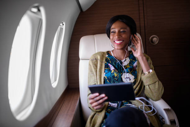 istock Woman in private jet airplane 907769422