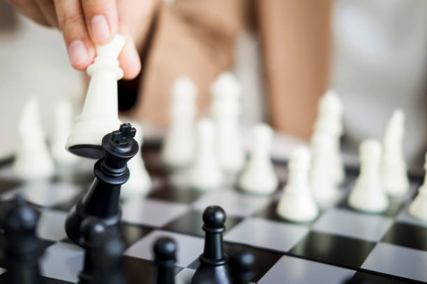 istock Close-Up Of Human Hand Playing Chess 907769614