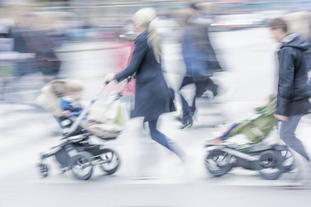 KALININGRAD, RUSSIA - MAY 21, 2016: Unknown mother with a baby carriage strolls along with the children in the Kaliningrad zoo.