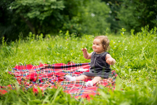 istock Baby girl playing in nature 907786916