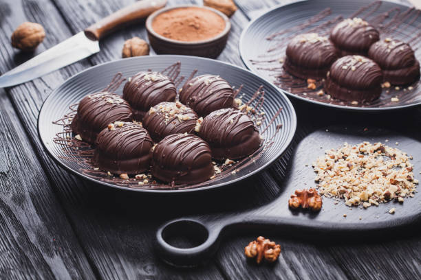 istock delicious mini chocolate cakes with walnut on a black wooden table 907787948