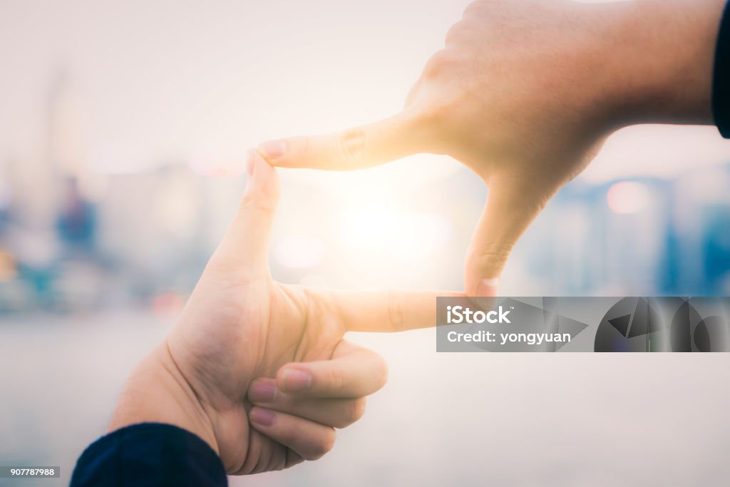 Framing for hope Using fingers to frame sunlight. Hand Stock Photo