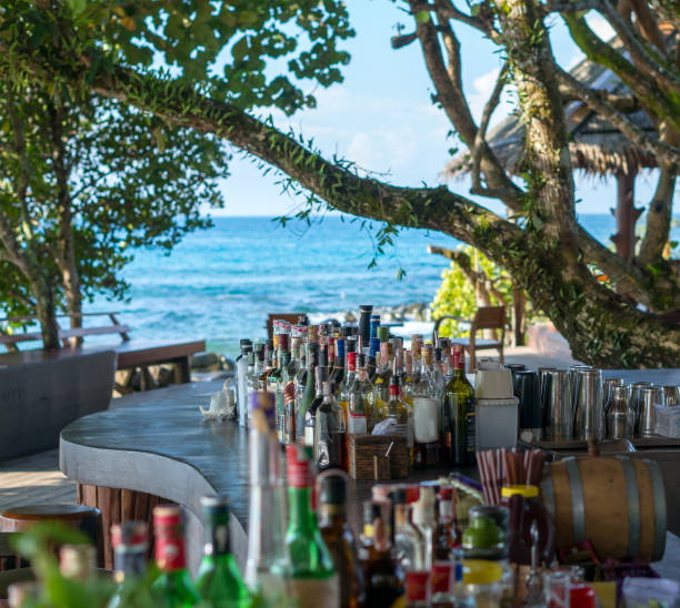 istock various bottles on a beach bar near a calm sea. 907788148