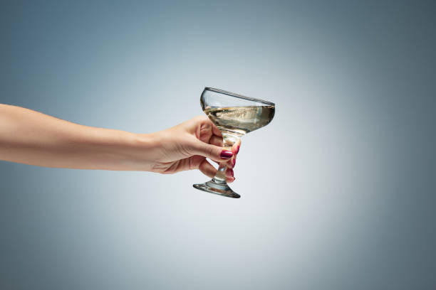 istock hand holding glass of wine 907811090