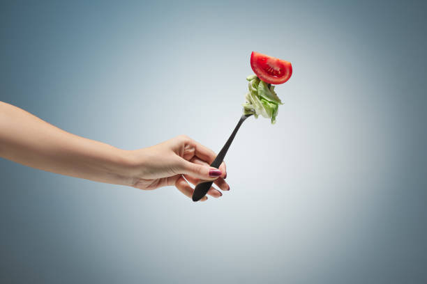 istock Beautiful woman hand holding a red rose 907811152
