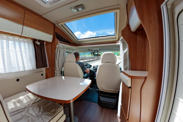 istock Man driving on a road in the Camper Van RV 907811578