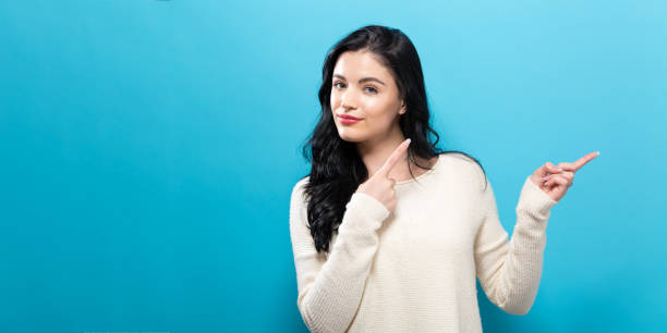 istock Young woman with a displaying hand gesture 907811924