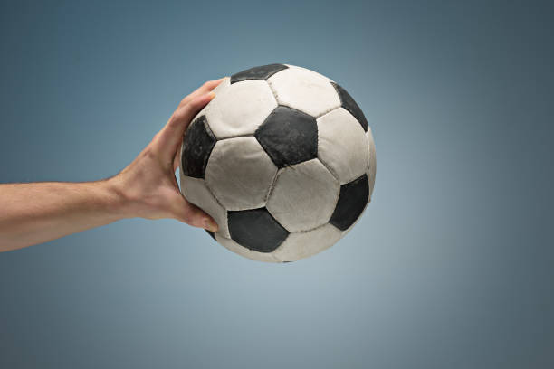 istock Hands holding soccer ball 907816284