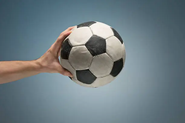 Photo of Hands holding soccer ball