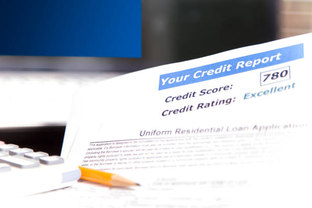 istock Credit report, score, loan documents, laptop, and calculator on desk. 907816742