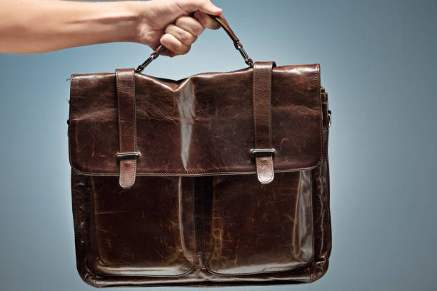 istock A man holding a brown leather travel bag 907819140