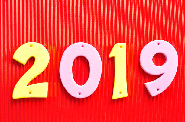 istock 2019 in pink and yellow numbers on a red background 907819668