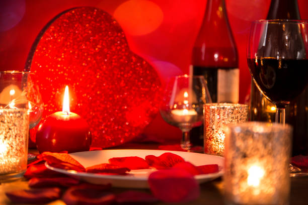 istock Valentine's Day romantic candlelight dinner with heart gift and wine. 907820382