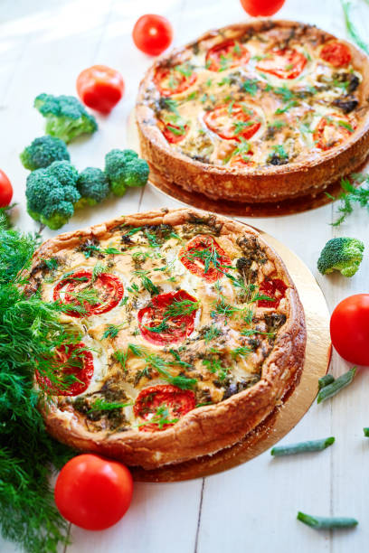 istock cheese cake with broccoli, green beans, tomatoes and Dill on white wooden table 907831354