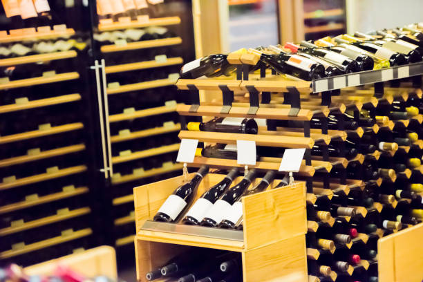 wine rack with different wines - wine cellar liquor store wine rack imagens e fotografias de stock