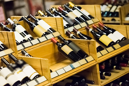 Wine rack with wine bottles, space for copy, selective focus