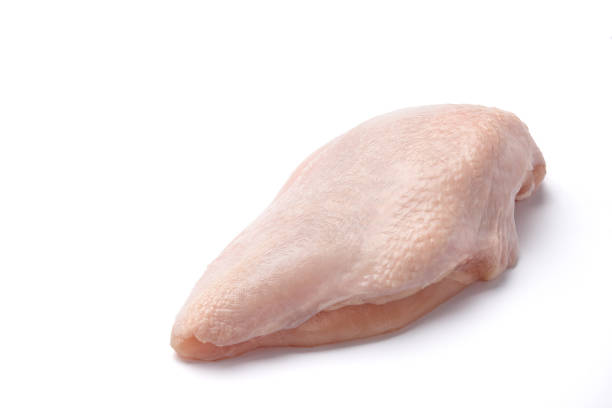 Raw chicken fillet isolated on white background Raw chicken fillet with skin isolated on white background giant cube stock pictures, royalty-free photos & images