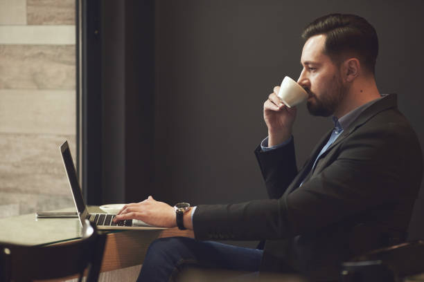 istock Businessman sitting in cafe. 907834888