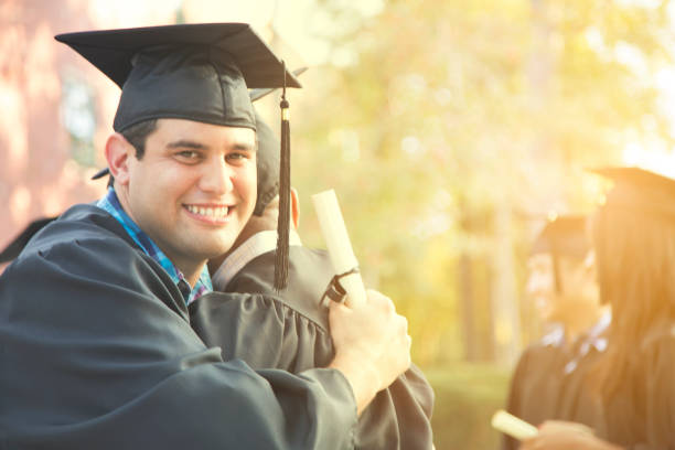 istock College student friends excitedly hug after graduation ceremony. 907837882