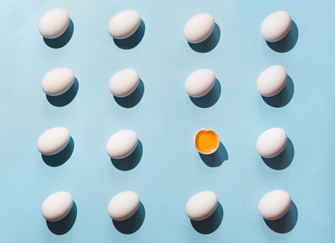 Organic white eggs on blue. Abstract pattern. Eggs in isometric.