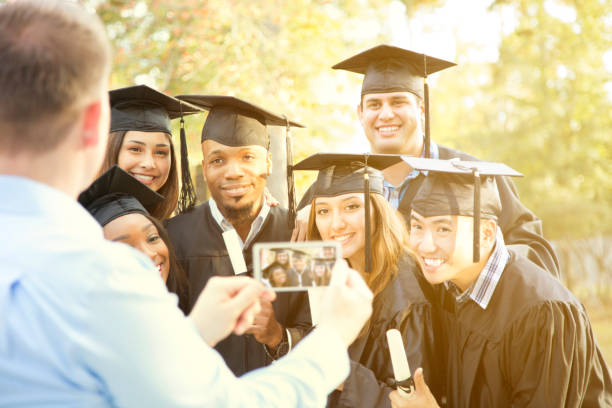 istock College students and father after graduation ceremony. 907838124