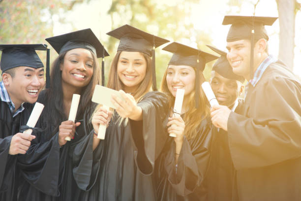 istock College student friends take selfie after graduation ceremony. 907838792