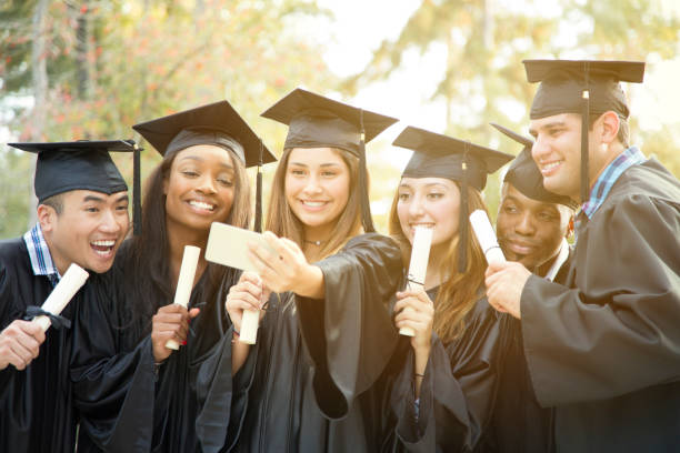 istock College student friends take selfie after graduation ceremony. 907843234