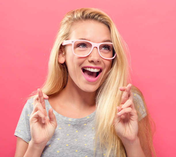 istock Young woman wishing for good luck 907844584
