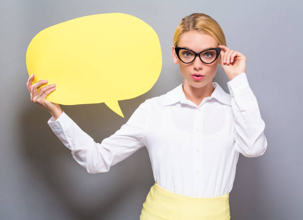 Young woman holding a speech bubble