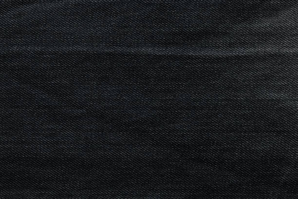 Black background, denim jeans background. Jeans texture, fabric.