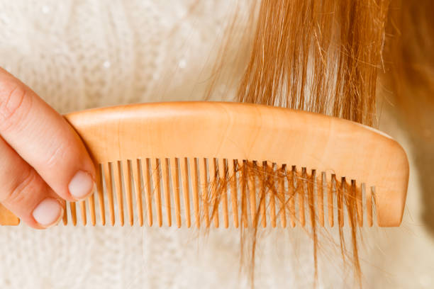 istock Female hand combing long hair. 907846336