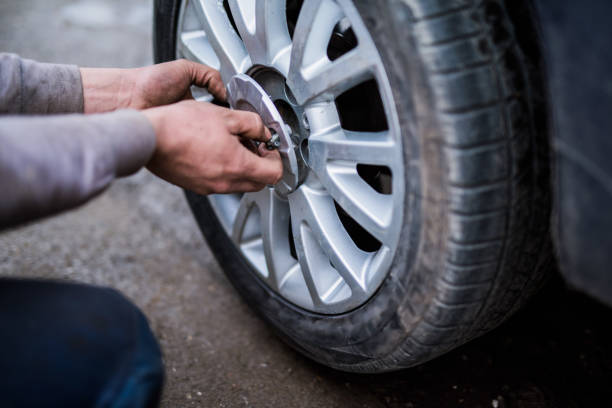 istock Mechanic removing a car wheel. 907846668