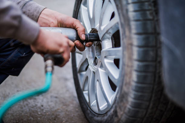 istock Mechanic putting new wheels on a car using a handgun. 907846920