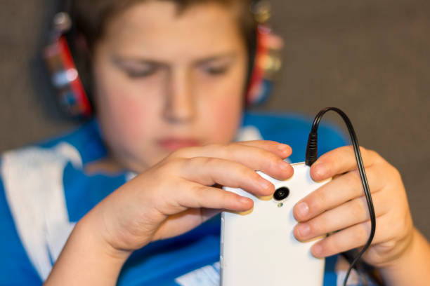 istock Boy with headphones and mobile phone in hand 907849164