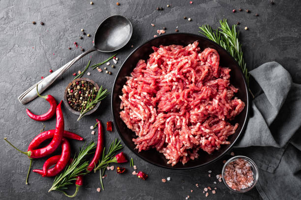 istock Mince. Ground meat with ingredients for cooking on black background. Top view 907849970