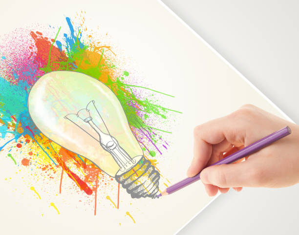 istock Hand drawing on paper a colorful splatter lightbulb 907851536