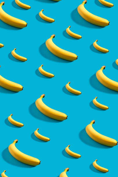 istock Colorful pattern of bananas on sky blue background 907851980