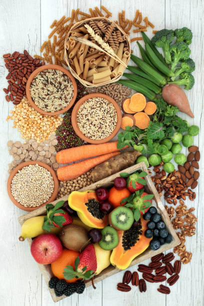 Health Food for a High Fiber Diet Health food for a high fiber diet with whole wheat pasta, grains, legumes, nuts, fruit, vegetables and cereals with foods high in omega 3 fatty acids, antioxidants and vitamins. Rustic background top view. probiotic photos stock pictures, royalty-free photos & images