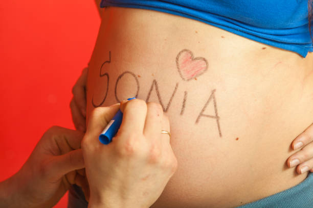 istock Pregnant woman belly with drawings 907852688