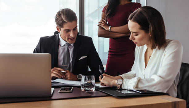 istock Boss dictating to assistant at office 907856776