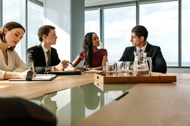 istock Group of corporate professionals having meeting 907857146