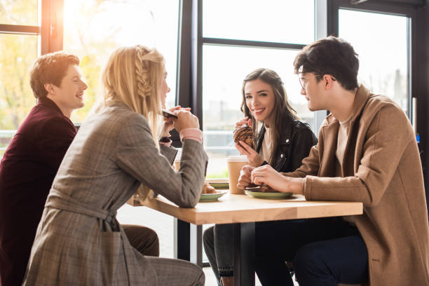istock Friends sitting at cafe 907858462