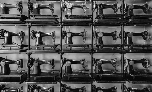 Old antique sewing machines. Background black and white pattern