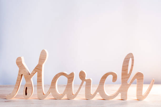 Word month of MARCH carved in wood with light background. Beginning of springtime. Spring hello concept Word month of MARCH carved in wood with light background. Beginning of springtime. Spring hello concept. march month photos stock pictures, royalty-free photos & images